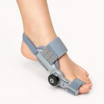 Hinged big toe straightener bunion splint worn on a foot with adjustment dial
