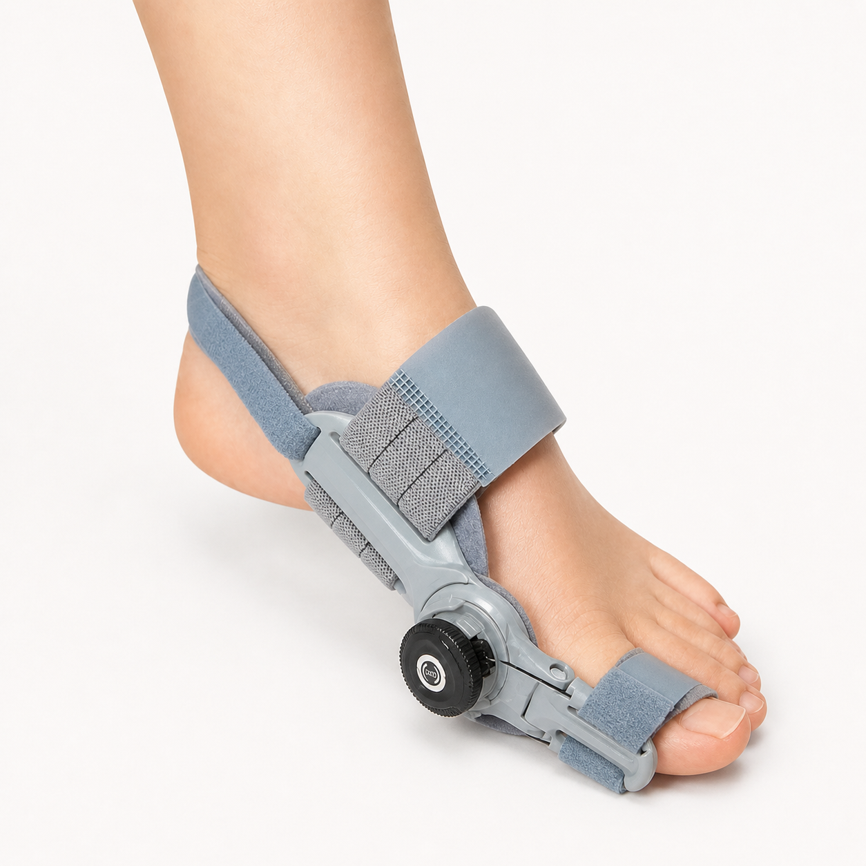 Hinged big toe straightener bunion splint worn on a foot with adjustment dial