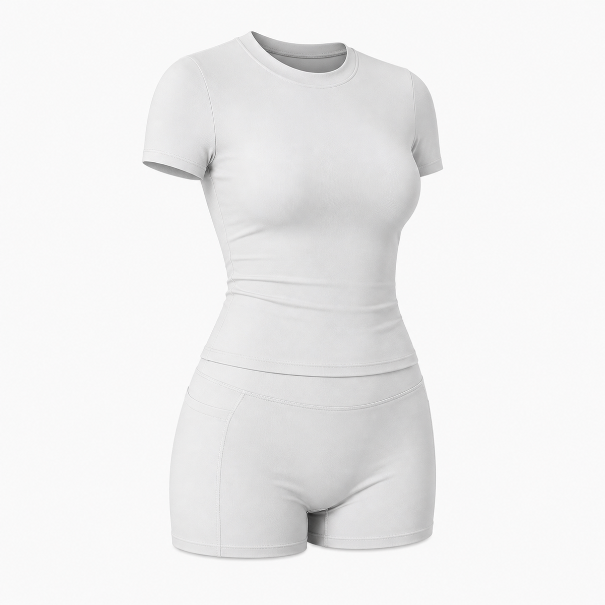 Matched yoga set with cropped tee and high waist biker shorts in soft window light