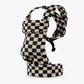 Child wearing a houndstooth waist bag at the hip during a park walk, hands free