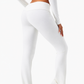 Flared yoga pants worn through a low lunge on a mat at home