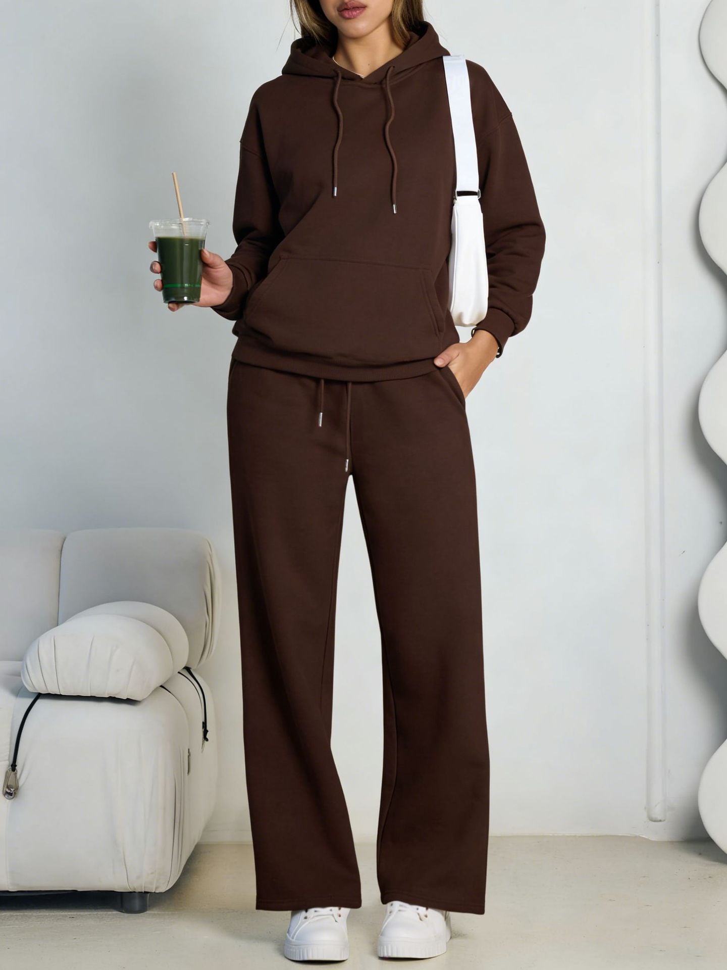 Brown fleece hooded sweatshirt and wide-leg sweatpants set worn by a model