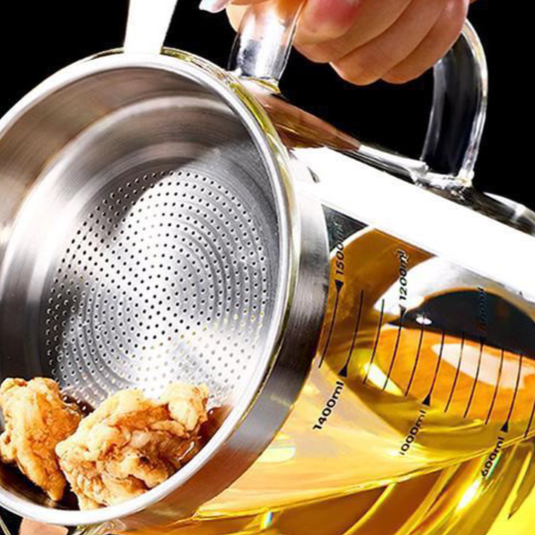 Close view of the perforated 304 steel strainer basket resting in the mouth of the glass oil jug