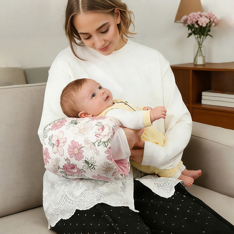 Nursing support pillow worn around the waist with baby resting on the cushioned curve