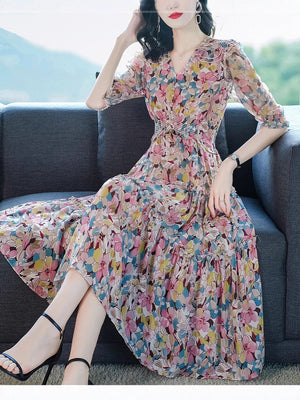 Floral silk midi dress side profile showing the fluid drape and puff sleeves