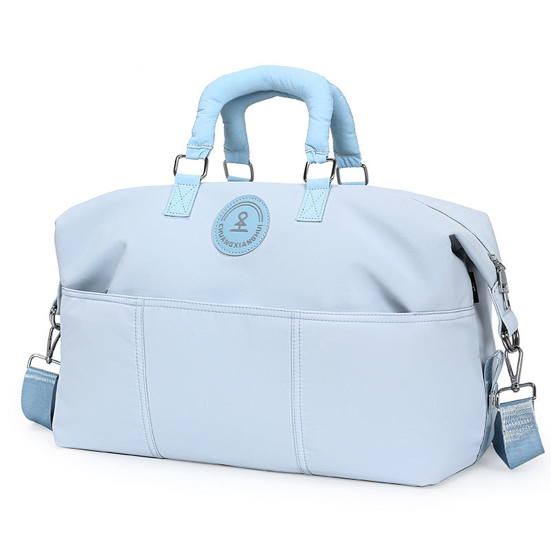 Light blue duffel travel bag with matching padded handles, front slip pockets and shoulder strap, option Light Blue