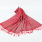 Red paisley jacquard scarf spread on a white background with twisted red tassel fringe