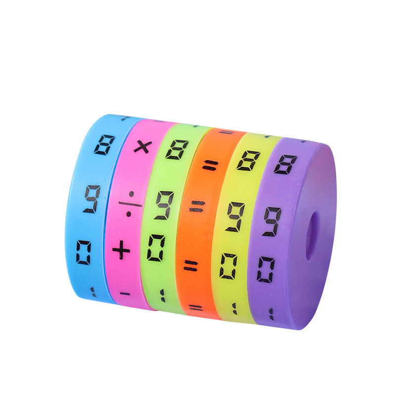 Plastic cylinder of six colored number rings with digits, times and divide signs on a white background