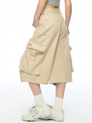 Back view of khaki cargo shorts showing patch pockets and wide leg drop