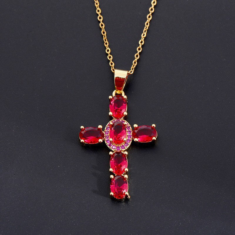 Cross pendant set with blue cubic zirconia stones on a slim plated chain