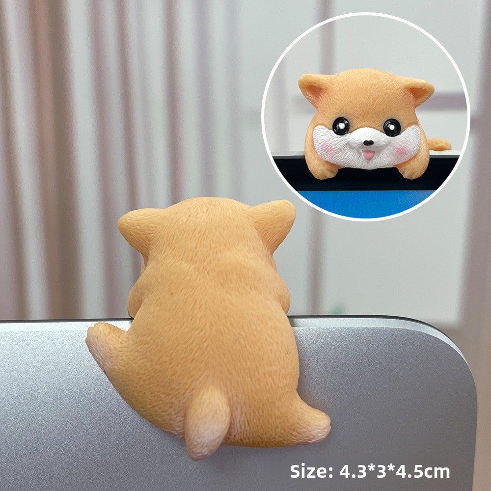 Tan shiba resin figurine seen from behind on a laptop edge with a front view inset