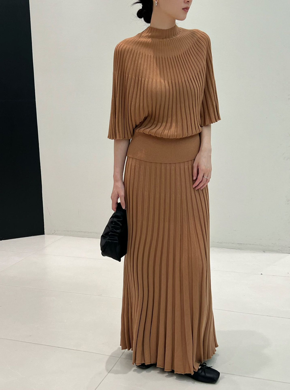 Amber brown caramel long ribbed knit skirt styled with a knit top and black bag, top not included