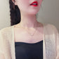 Gold tone and silver tone star necklaces laid on a cream ripple plate