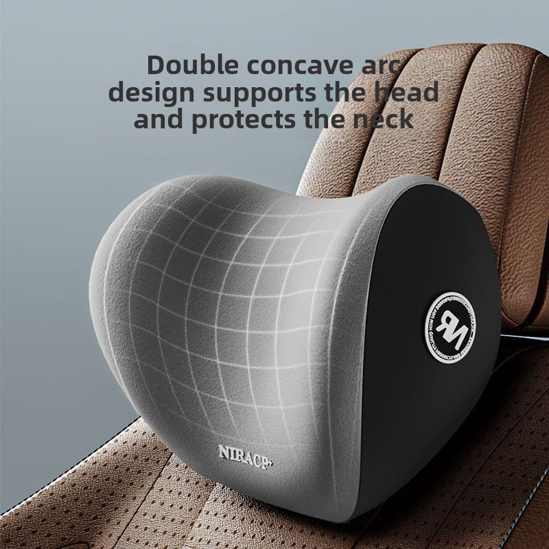 Gray double concave neck headrest pillow shown close up above a car seat