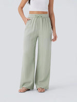 Linen yoga pants with drawstring waist worn in a relaxed lifestyle setting