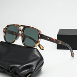 Square double bridge sunglasses with a tortoise frame and green lenses on a black case