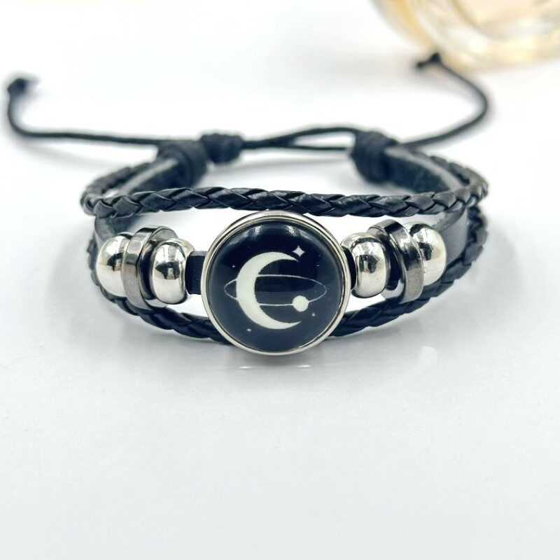 Pink braided cord bracelet with a sea charm shown at an angle