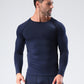 Man in a navy long sleeve compression shirt with raglan sleeves, looking to the side