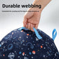 Hand lifting a navy planet print dog ball by one of its woven grab loops