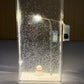 Clear acrylic Christmas light box with a slim LED street lamp glowing through fine faux snow flakes