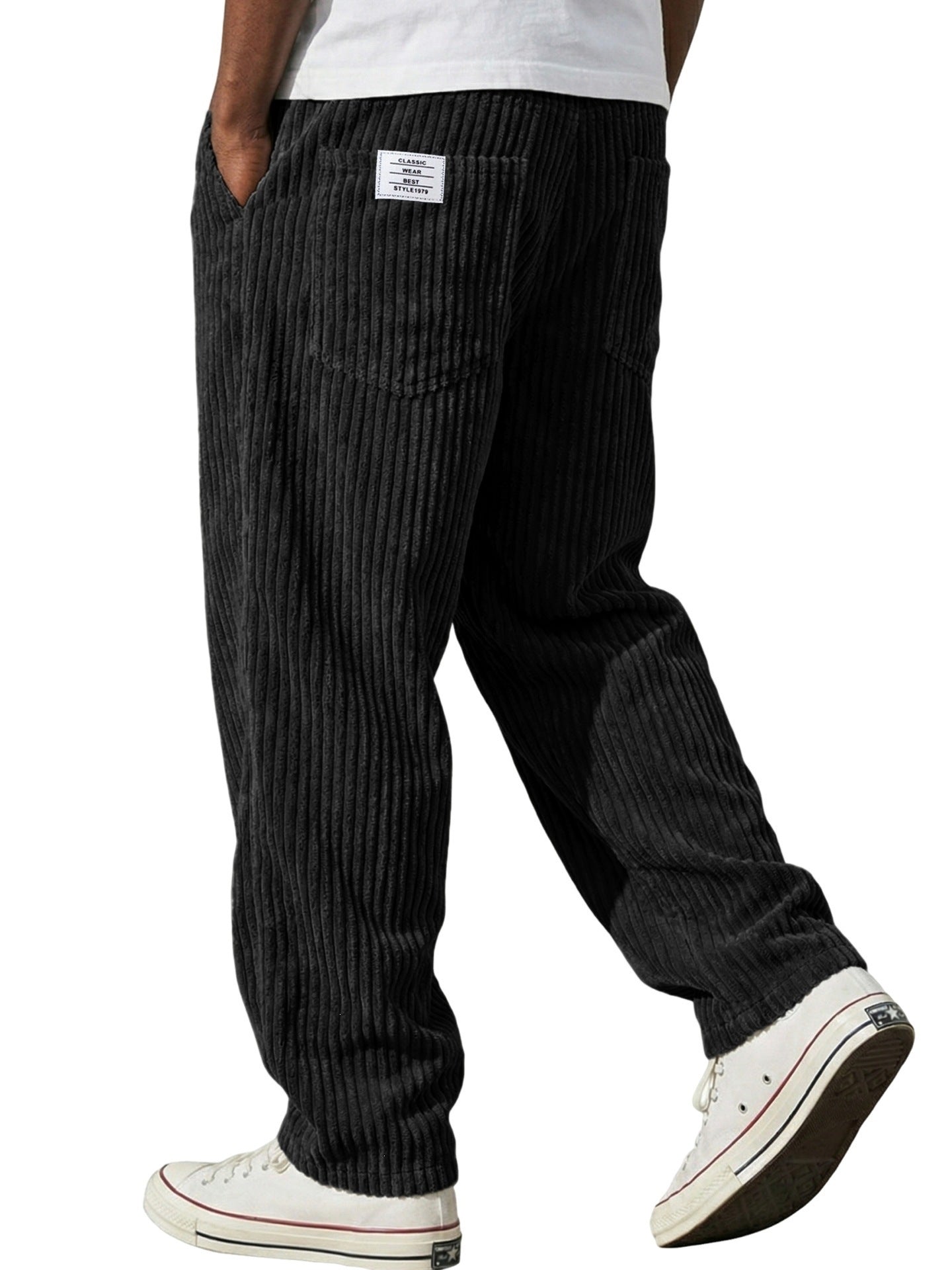Corduroy trousers worn with a plain tee to show the relaxed straight leg cut