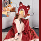 Plush animal face hood and paw cuff detail on a flannel hooded cape blanket