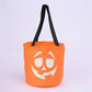 Glow in the dark pumpkin face candy bucket shown against a dark background