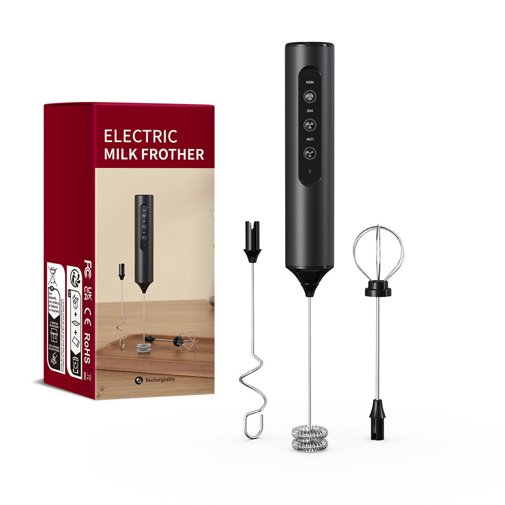 Black handheld electric milk frother with red retail box and two spare whisk heads