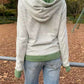 Back view of the green striped zip-up hoodie showing the hood, green hood lining and ribbed hem