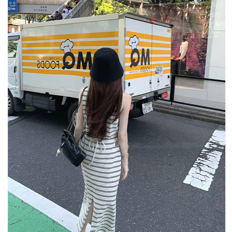 Back view of striped sleeveless maxi dress showing waist drawstring tie and slim skirt