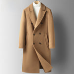 Camel double-breasted long coat with peak lapels on a hanger over a white turtleneck, front view