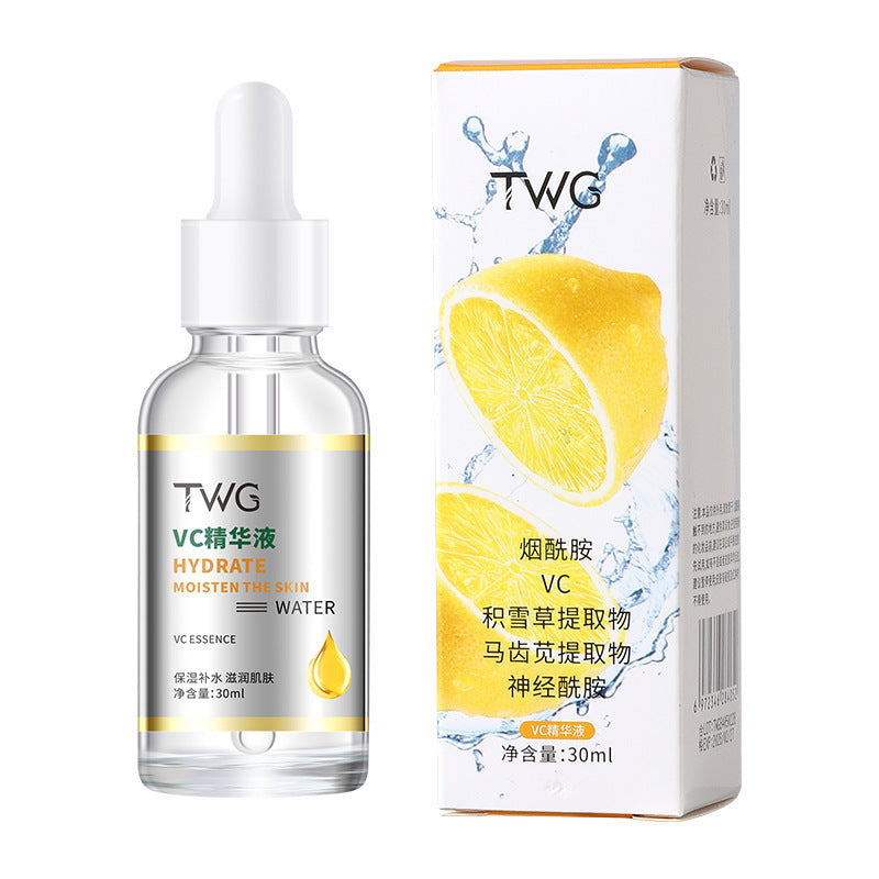 Clear TWG VC essence dropper bottle standing next to its lemon print ingredient carton