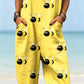 Size XL option: Yellow overalls with a black bee print, cuffed legs and front pockets on a beach