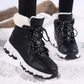 Black lace up snow boots worn with leggings, moulded lace loops and white midsole visible