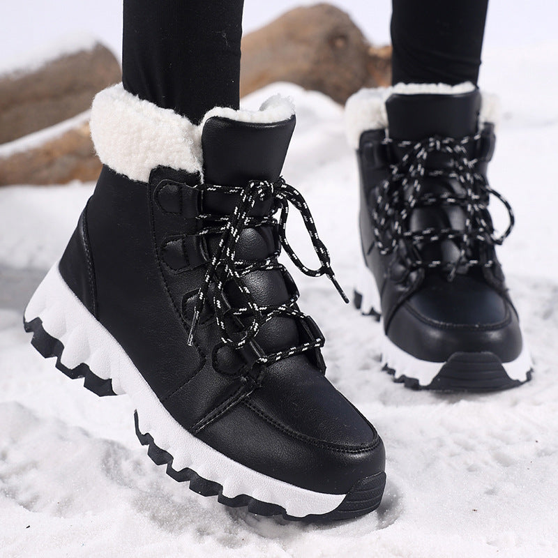 Black lace up snow boots worn with leggings, moulded lace loops and white midsole visible
