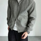 Man wearing the linen stand collar jacket over a tee with the front zip half open