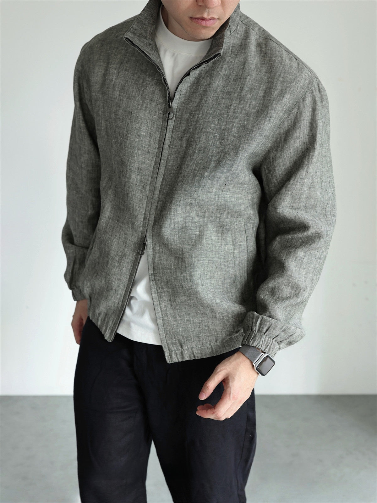 Man wearing the linen stand collar jacket over a tee with the front zip half open