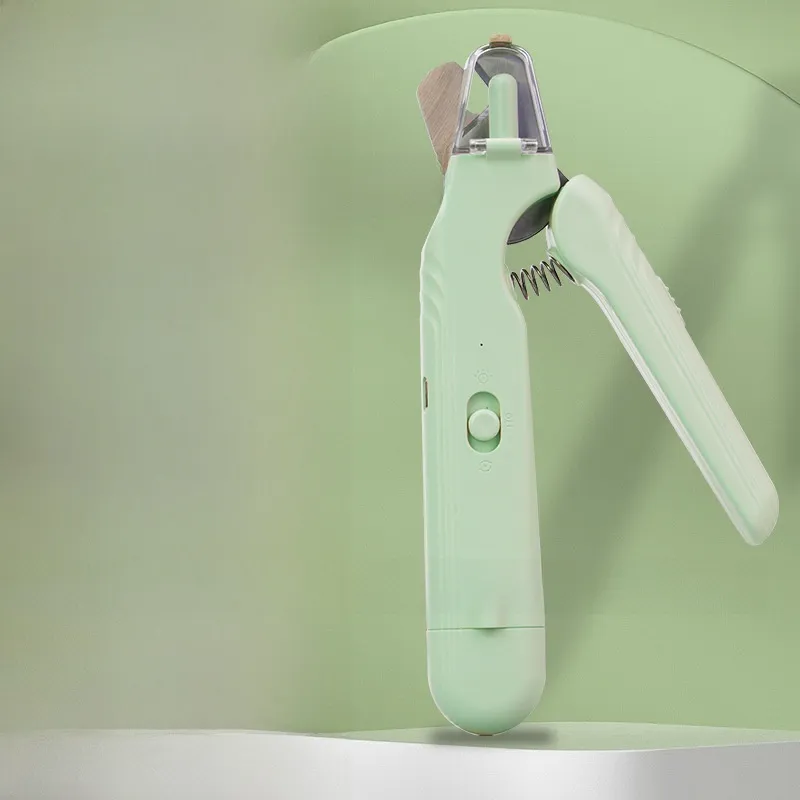 Green pet nail clipper with clear guard and speed switch on a green studio background
