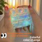 Nine key clear keycap clicker glowing rainbow color, held between two hands