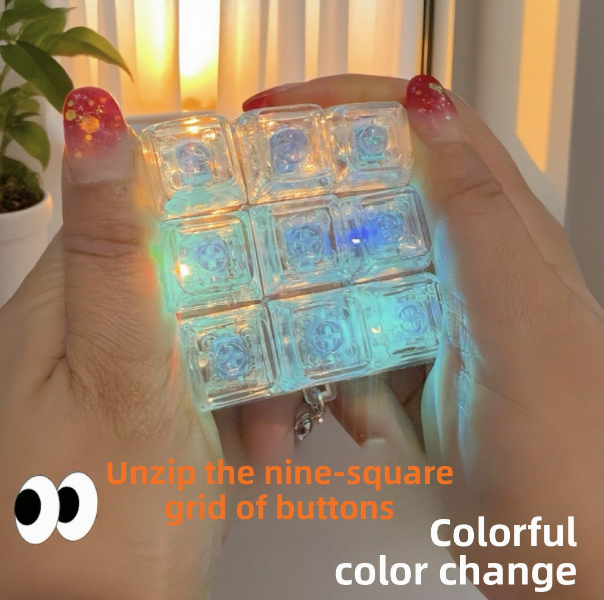 Nine key clear keycap clicker glowing rainbow color, held between two hands