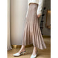 Ribbed wool midi skirt styled with a tucked knit and boots