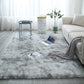 Soft shaggy polyester rug under a coffee table on a pale wood floor surface