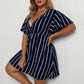 Navy blue and white striped surplice mini dress with flutter sleeves, worn front view