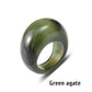 Dark green agate stone ring carved solid on a white background