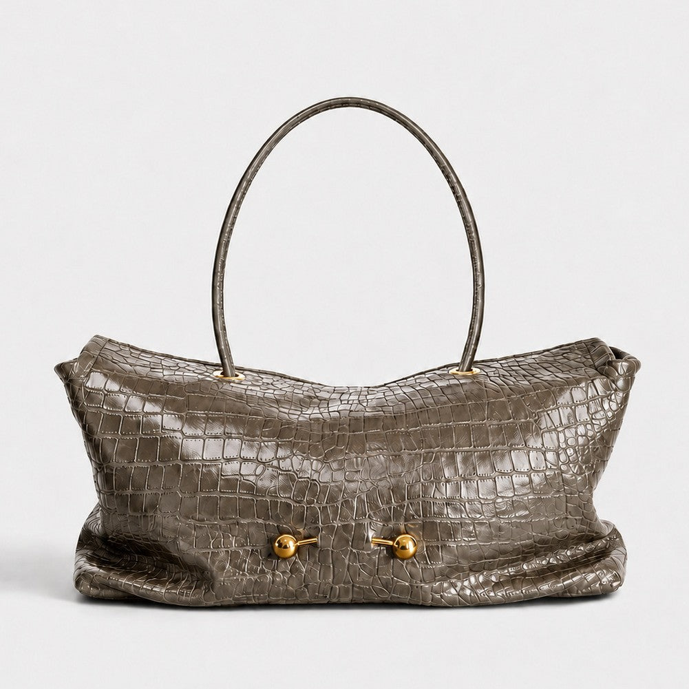 Taupe croc embossed shoulder bag with two gold ball studs and one round top handle on white