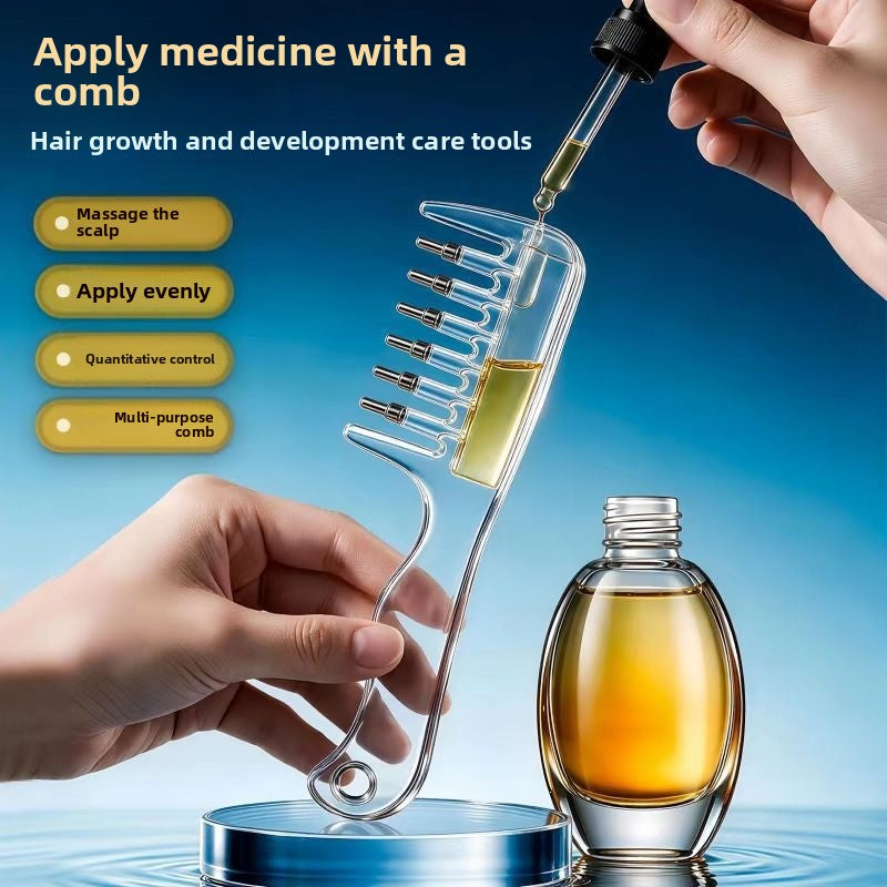 Hand filling the clear hair comb reservoir with a dropper next to a bottle of amber oil