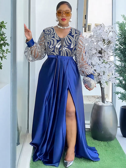 Blue maxi dress with silver sequin mesh bodice and lantern sleeves, front slit, worn standing