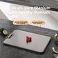 Titanium-faced cutting board in use during kitchen prep with a knife