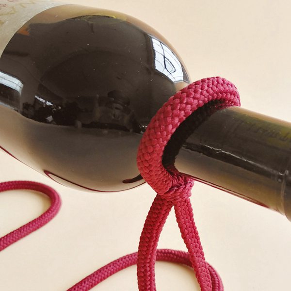 Close-up of a burgundy braided rope loop around the neck of a wine bottle, burgundy color not offered