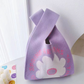 Soft knit wrist bag with an open top and a jacquard knitted pattern
